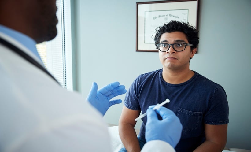 Patient discussing vaccination decisions with rheumatology clinician during appointment