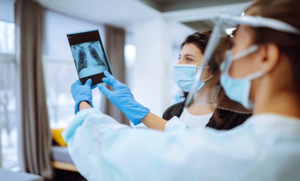 Clinician reviewing lung imaging for tuberculosis precision medicine and clinical phenotype assessment