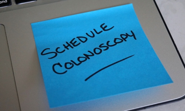 Sticky note reminder for colorectal cancer screening amid Medicaid eligibility restrictions.