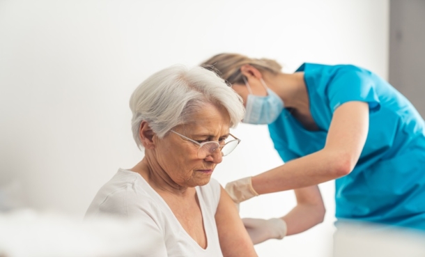 Older adult receiving shingles vaccine, illustrating herpes zoster vaccination and incident dementia research