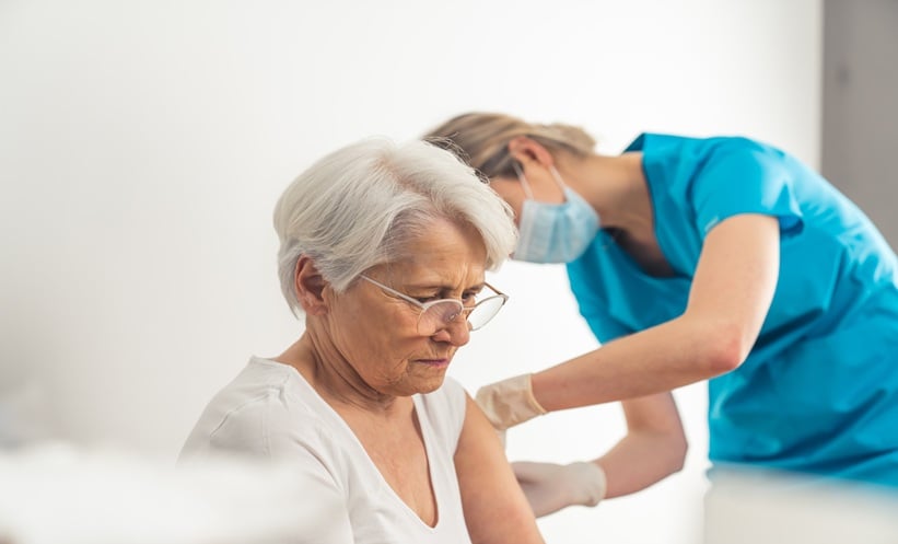 Older adult receiving shingles vaccine, illustrating herpes zoster vaccination and incident dementia research