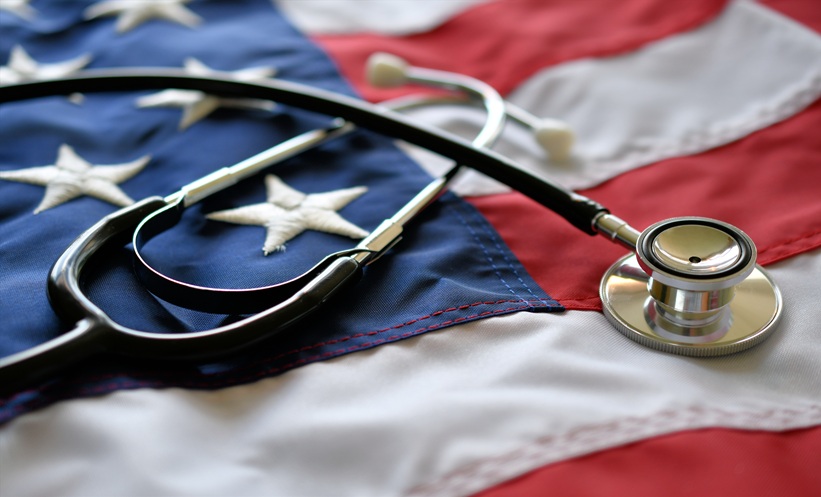 Stethoscope resting on an American flag symbolizing healthcare for post-9/11 veterans affected by deployment-related smoke exposure and lung disease