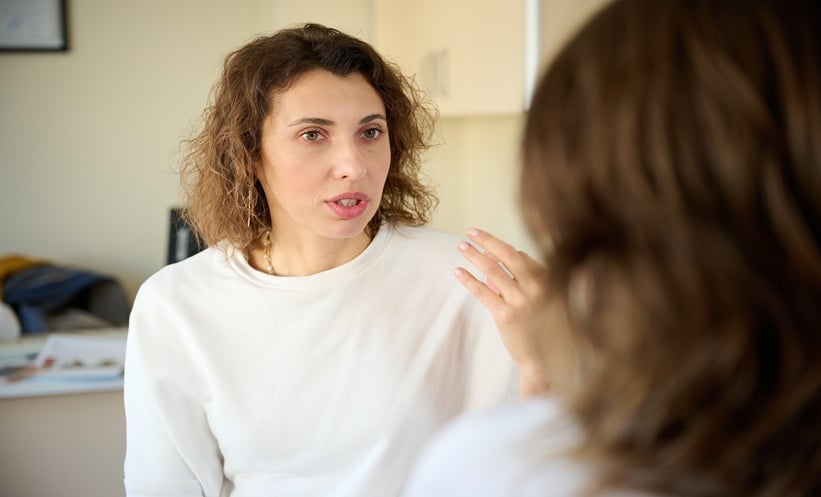 Patient and clinician discussing functional neurologic disorder care and diagnosis in a neurology clinic.