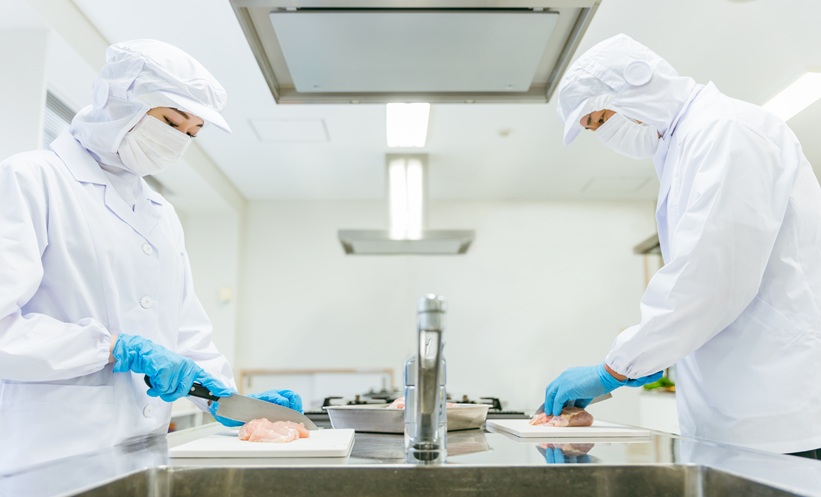 Food processing workers handling meat byproducts for bioactive peptides and sustainable nutrition