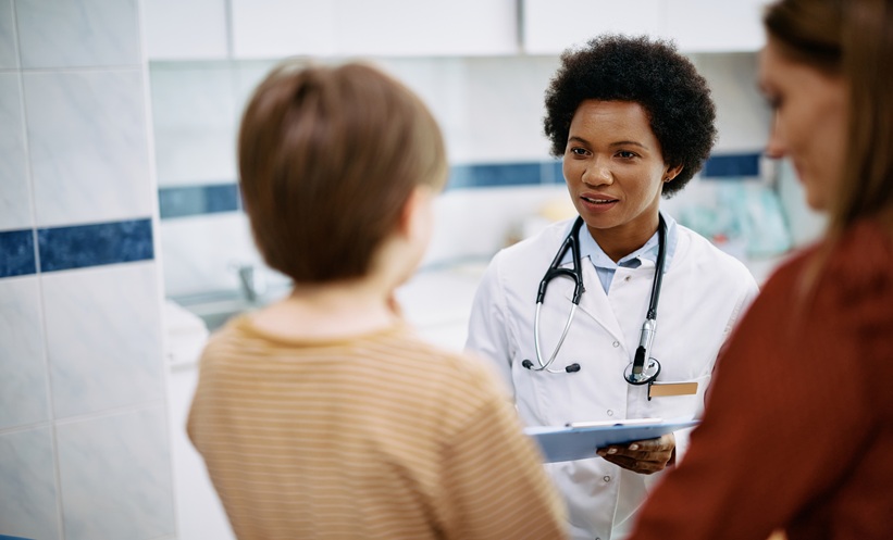 Young adult patient with epilepsy speaking with neurologist about cenobamate treatment for tuberous sclerosis complex
