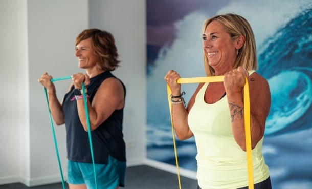 Older adult performing resistance exercise with trainer, concept for brain aging clocks and brain health