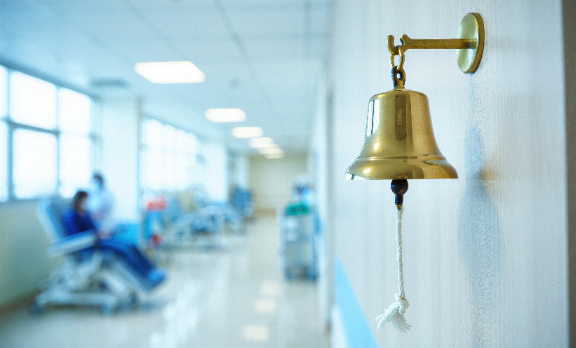 Bell in focus in hospital hallway