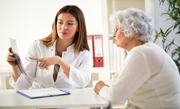 Doctor discussing scan results with patient during clinical consultation