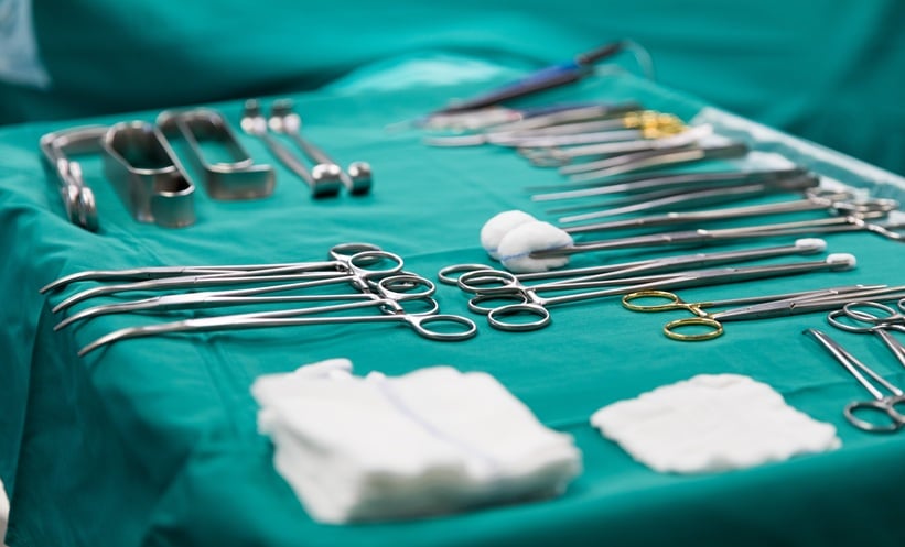 Operating room team preparing for sustainable breast cancer surgery with reusable surgical materials and breast procedure setup