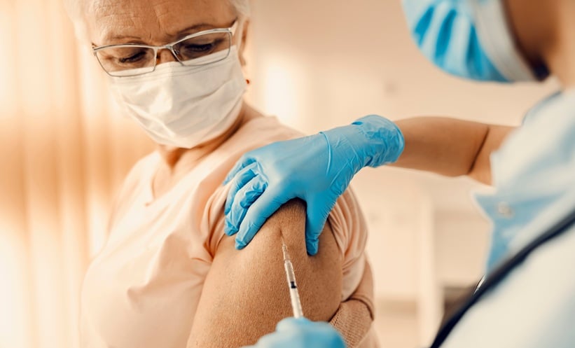 Older adult speaking with a healthcare professional about RSV vaccination and respiratory infection prevention