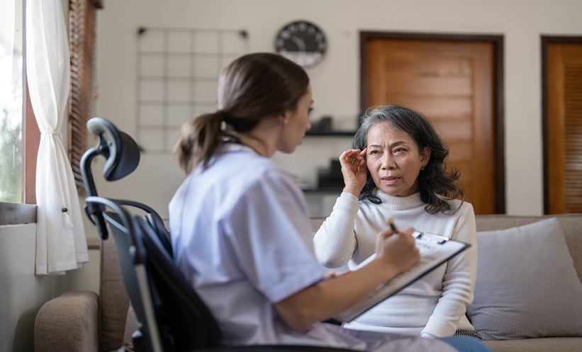 Older adult undergoing hearing assessment during cognitive clinic evaluation for mild cognitive impairment