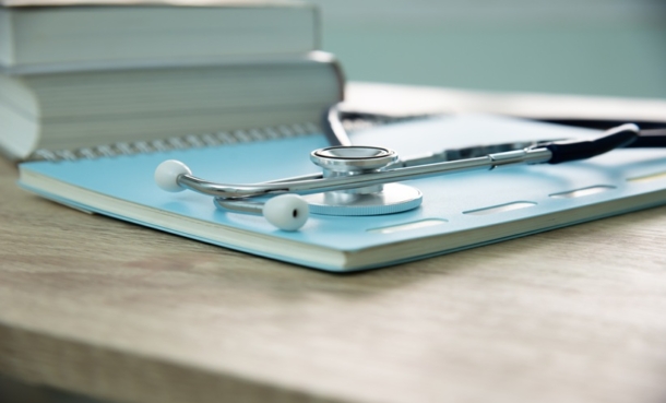 Stethoscope resting on a notebook, representing healthcare education and training
