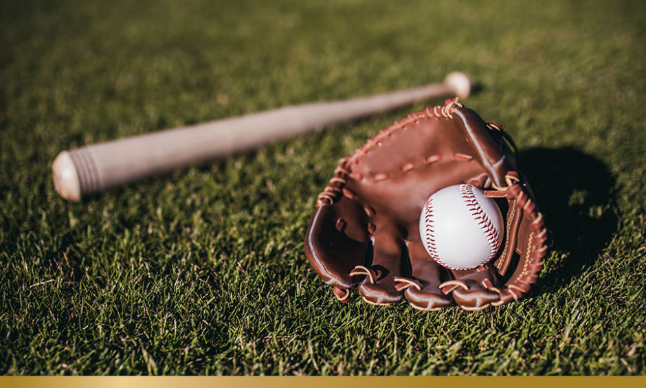 Baseball, bat and glove on the grass