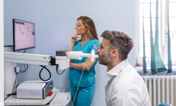 Man testing breathing function by spirometry. Diagnosis of respiratory function in pulmonary disease