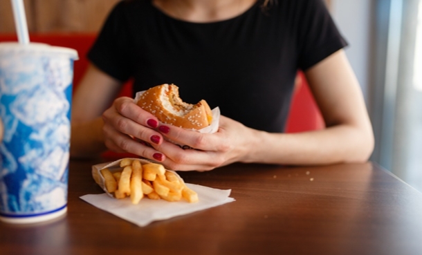 Girl eating a fast-food burger.