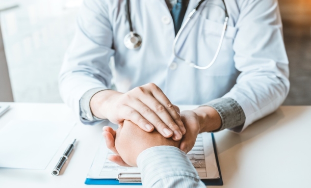 Primary care consultation illustrating health care barriers and cancer screening access.