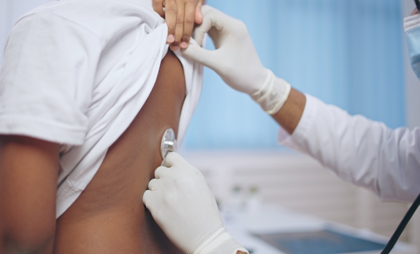 Doctor examining a patient's lungs using a stethoscope.