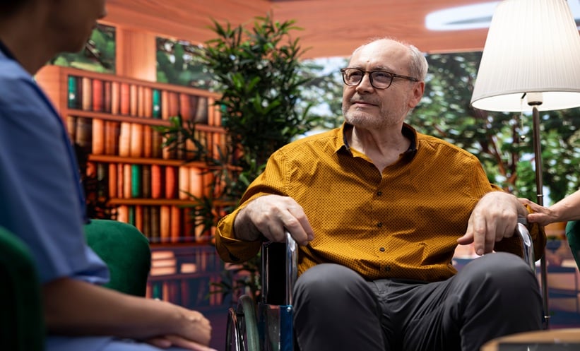 Older adult using a wheelchair during a clinical consultation, reflecting activity limitation linked to long COVID.