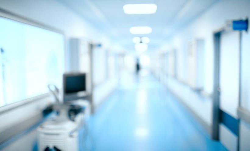Blurred hospital corridor representing clinical outcomes after private equity hospital acquisition.