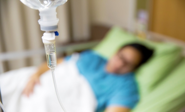 Patient receiving time-of-day immunotherapy infusion for advanced cancer treatment.