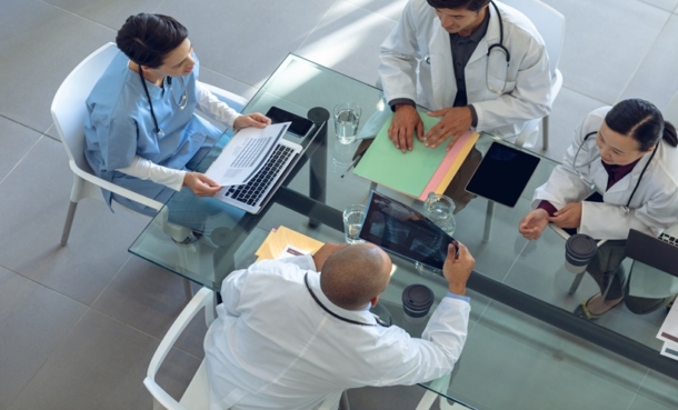 Hospitalist and oncology clinician discussing inpatient cancer care gaps in a hospital setting