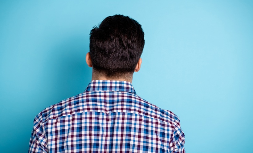 Back view of a man’s head and neck, representing head and neck skin lesions and dermatology assessment.