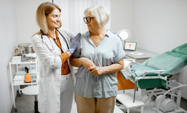 Clinician supporting an older woman during a consultation about HIV menopause care.