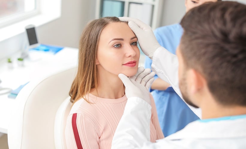 Clinician speaking with a patient during a cosmetic dermatology consultation.
