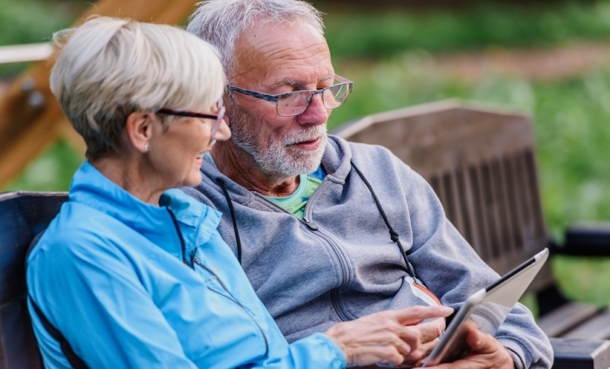Older patient with cancer using a tablet during a healthcare consultation about digital health technophobia.