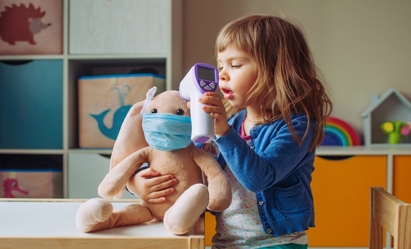 Child with asthma inhaler during extreme heat, representing asthma emergency department risk in urban neighborhoods.