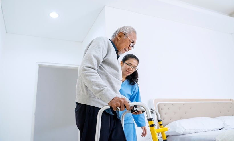 Patient undergoing stroke rehabilitation with clinician support, representing new-onset constipation after stroke and recovery outcomes.