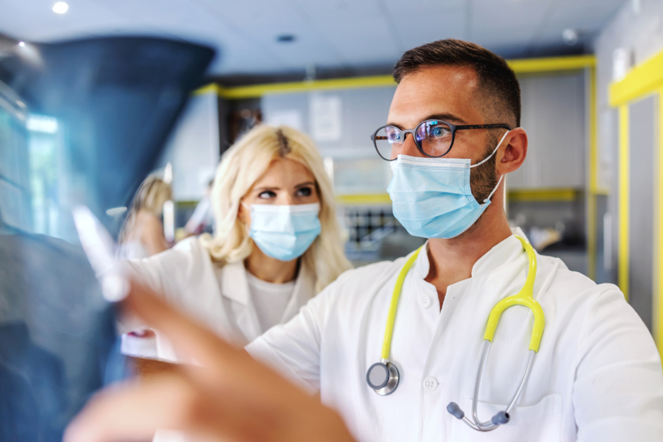 Healthcare professionals reviewing imaging for pulmonary arterial hypertension care.
