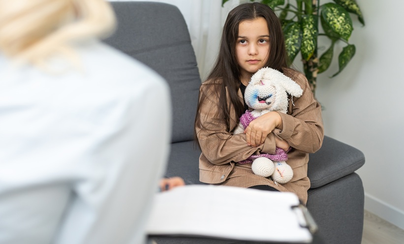 Physician discussing cognitive screening and childhood lupus care with a young patient and caregiver.