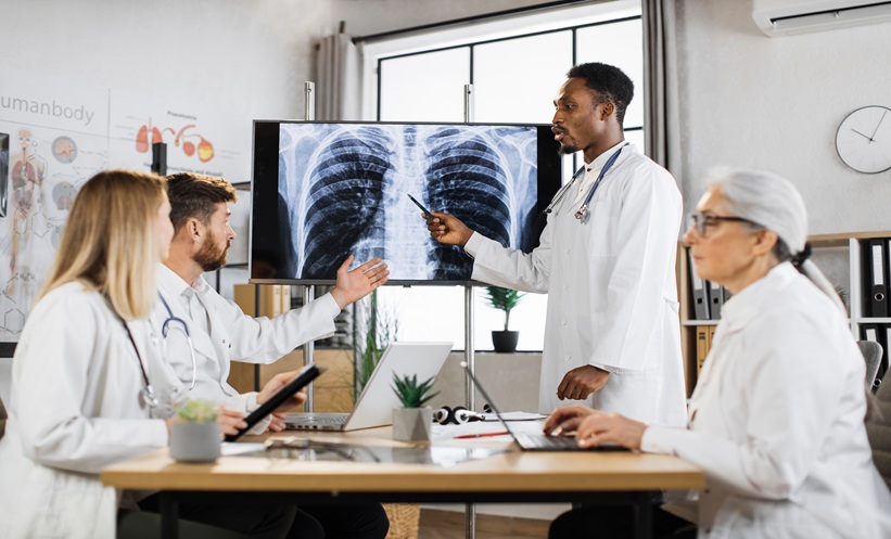 Clinicians reviewing lung imaging in a discussion about nontuberculous mycobacterial lung disease.