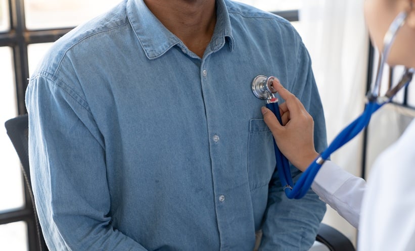 Doctor performing a lung exam during assessment for fibrotic interstitial lung disease.