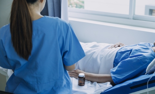 Older adult with cancer discussing palliative nursing interventions and quality of life with a clinician.