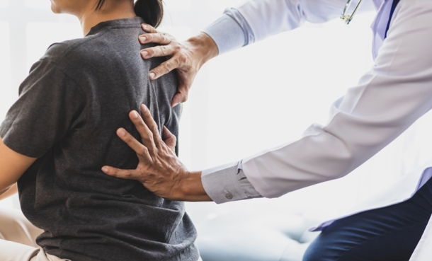 Physician discussing cancer-related bone pain treatment with a patient in clinic