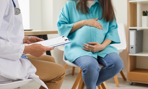 Pregnant patient discussing hepatitis E vaccine safety with a healthcare professional.