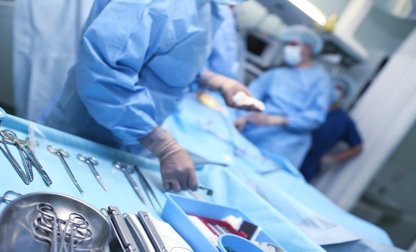 Older adult discussing colon cancer treatment interval and surgery planning with physician
