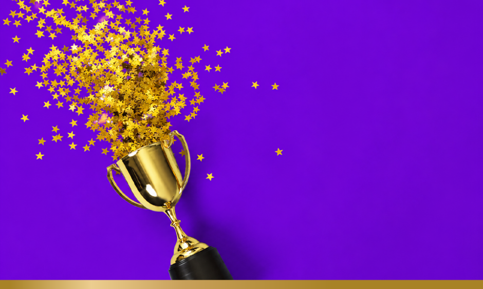 Trophy with stars spilling out of it on purple background