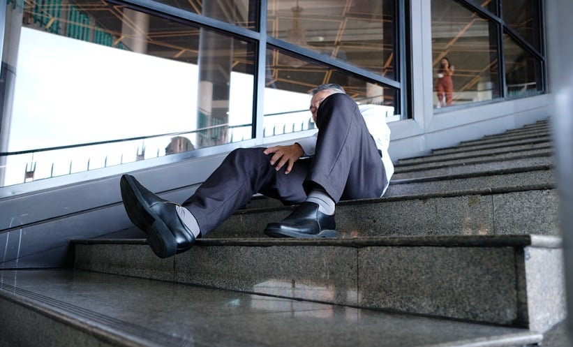 Older adult after a fall on stairs, illustrating mild traumatic brain injury assessment.
