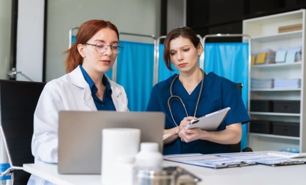 Clinician reviewing remote monitoring data for a patient recovering after sepsis hospitalization