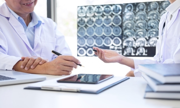 Clinician reviewing brain scan for traumatic encephalopathy syndrome after traumatic brain injury.