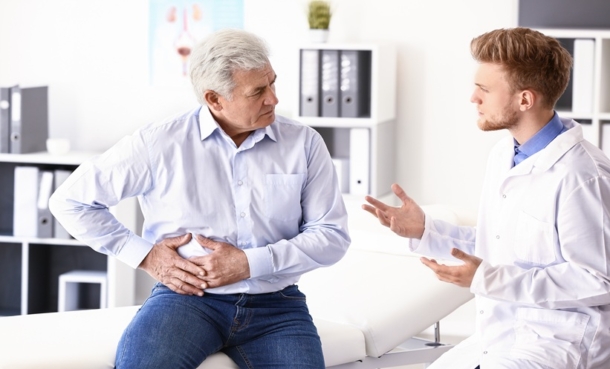 Physician reviewing localized prostate cancer treatment outcomes and healthcare costs with a patient.