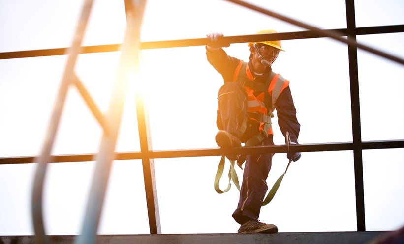 Outdoor worker protected from sunlight to reduce occupational solar UV exposure and melanoma risk.