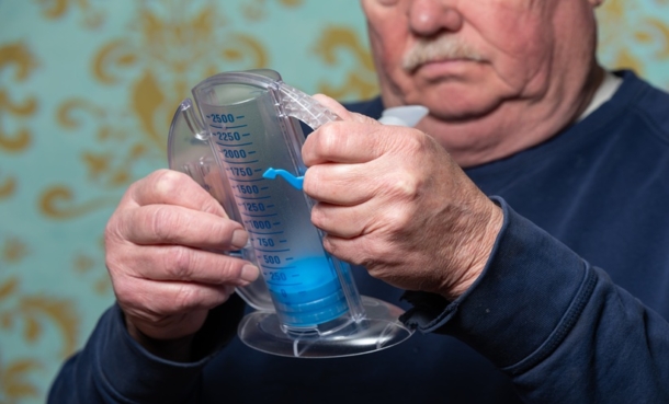 Clinician reviewing cystic fibrosis care utilization data with patient in respiratory clinic