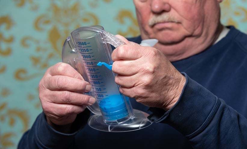 Clinician reviewing cystic fibrosis care utilization data with patient in respiratory clinic