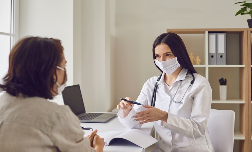 Healthcare professional discussing metformin and long COVID symptoms with an outpatient after COVID-19 infection.