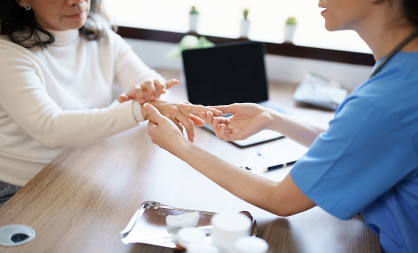 Patient with rheumatoid arthritis speaking with clinician about social support, coping, and stigma.