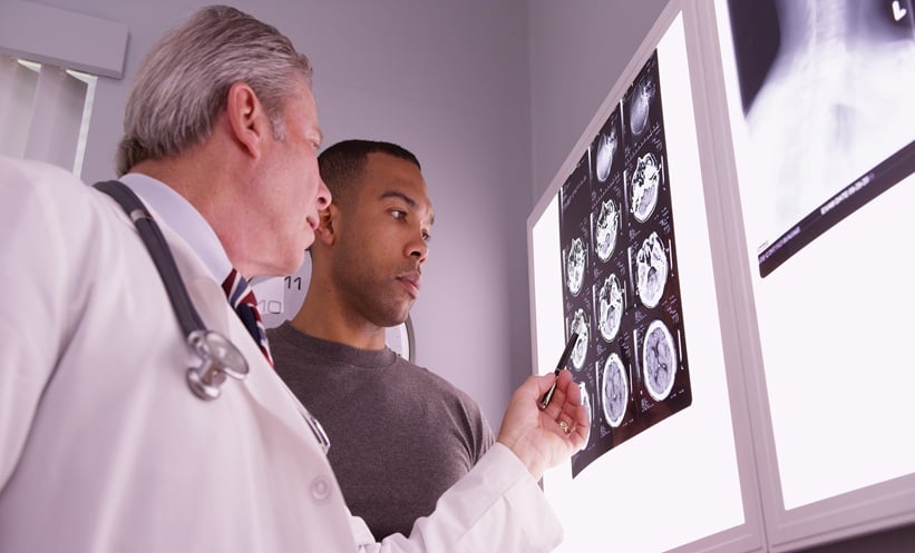 Doctor reviews x ray of patient with TBI